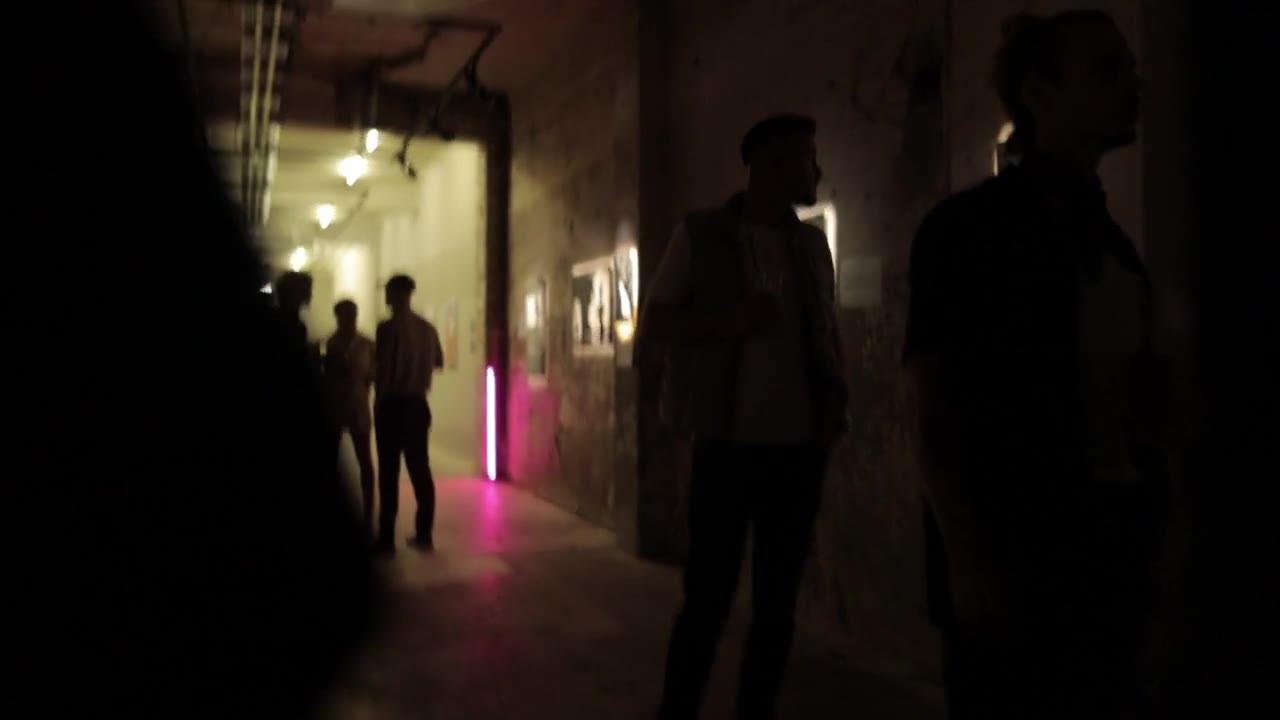 Real guests in conversation beside framed art during an ARTFÊTE edition
