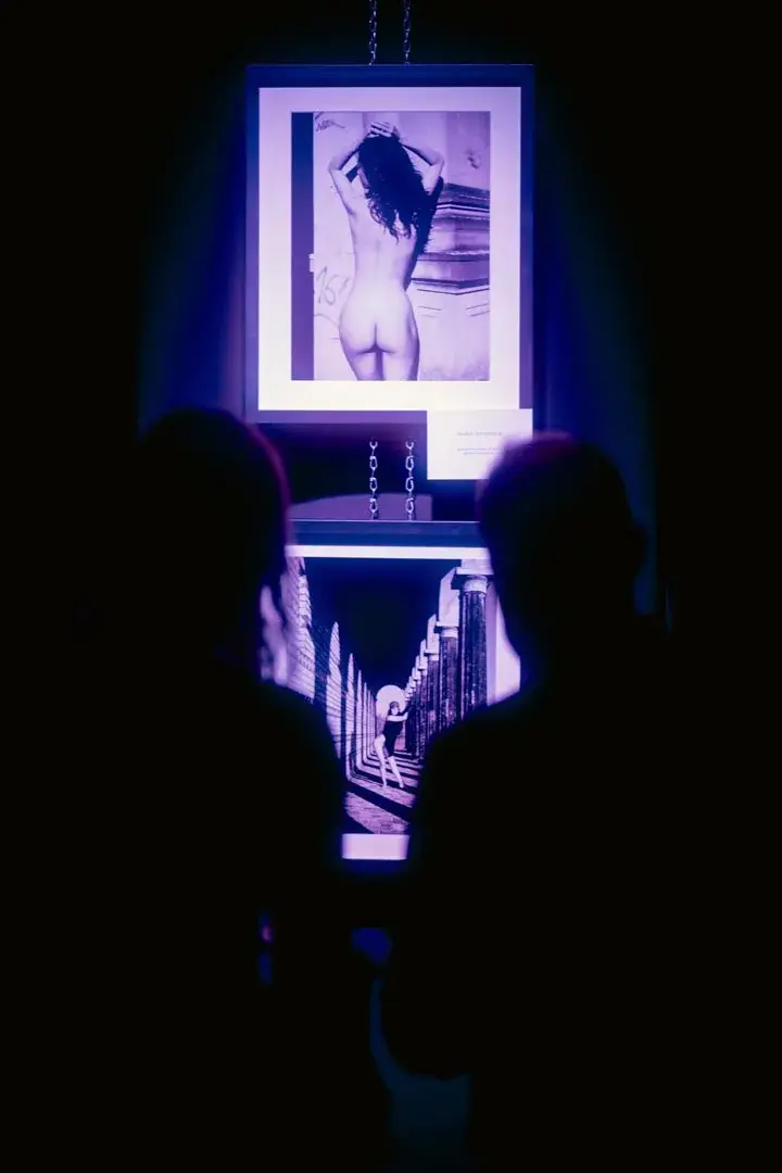 A silhouette in front of an immersive digital work